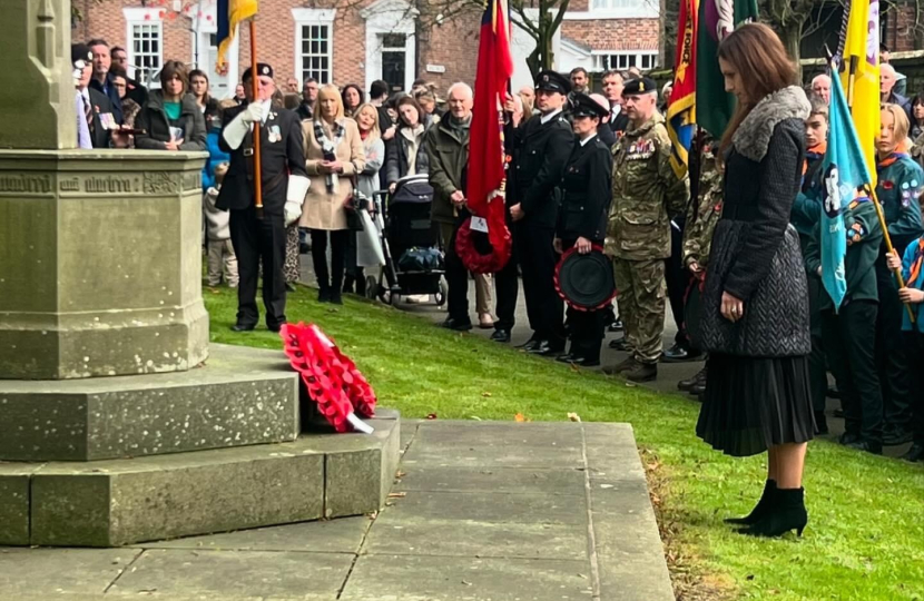 Aphra Brandreth MP laying a wreath