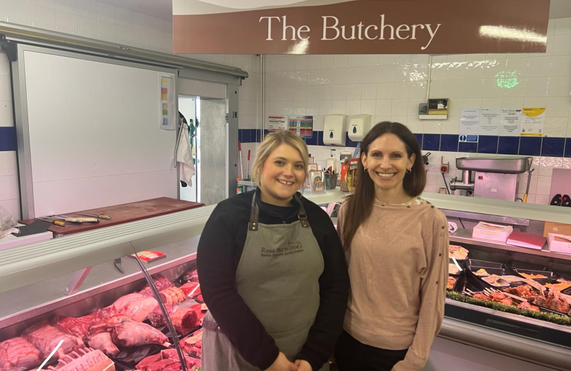 Photo of Aphra in front of the Butchery at Rose Farm Shop